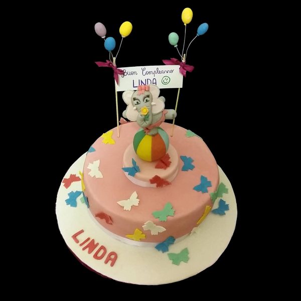 Torta decorata in pasta di zucchero con un elefantino equilibrista per un compleanno